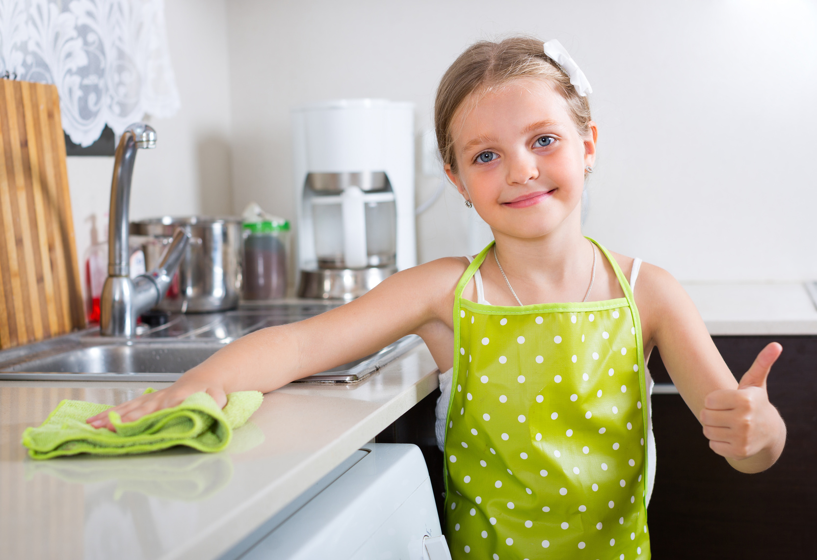 household chores for kids - girl wiping kitchen counter