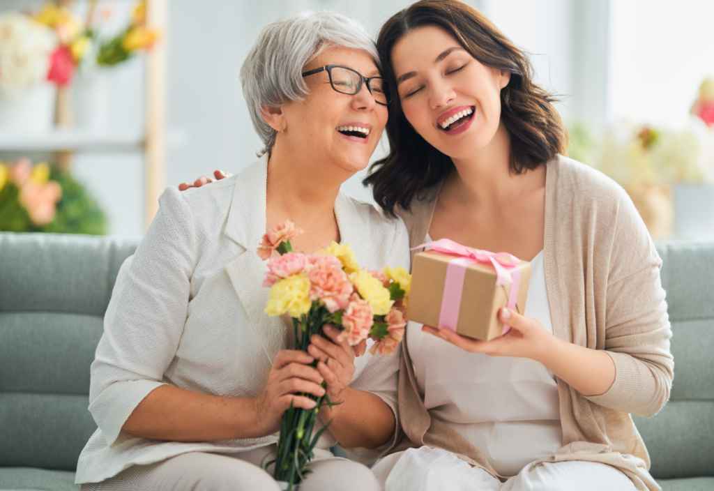 Professional house cleaning is the perfect gift - two generations of women smiling and enjoying giving each other gifts